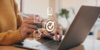 Hand of young woman holding a pen pointing to document and mark correct sign. Hand of young woman holding a pen pointing to document and mark correct sign for standard quality control certification assurance concept.